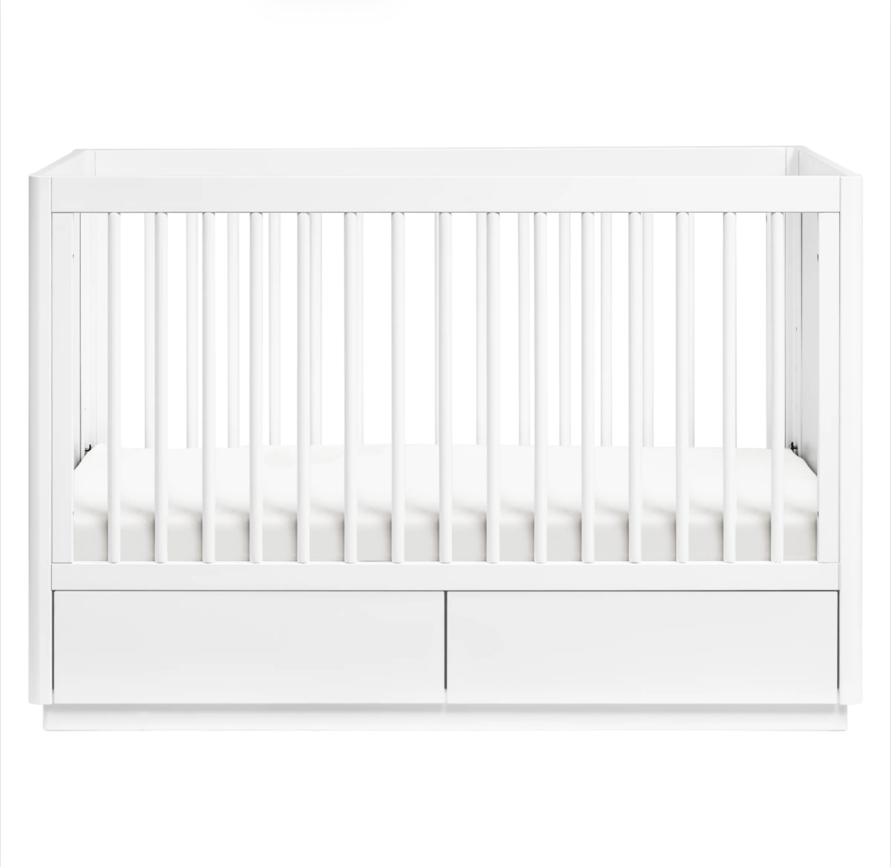 White convertible baby crib with built-in storage drawers.