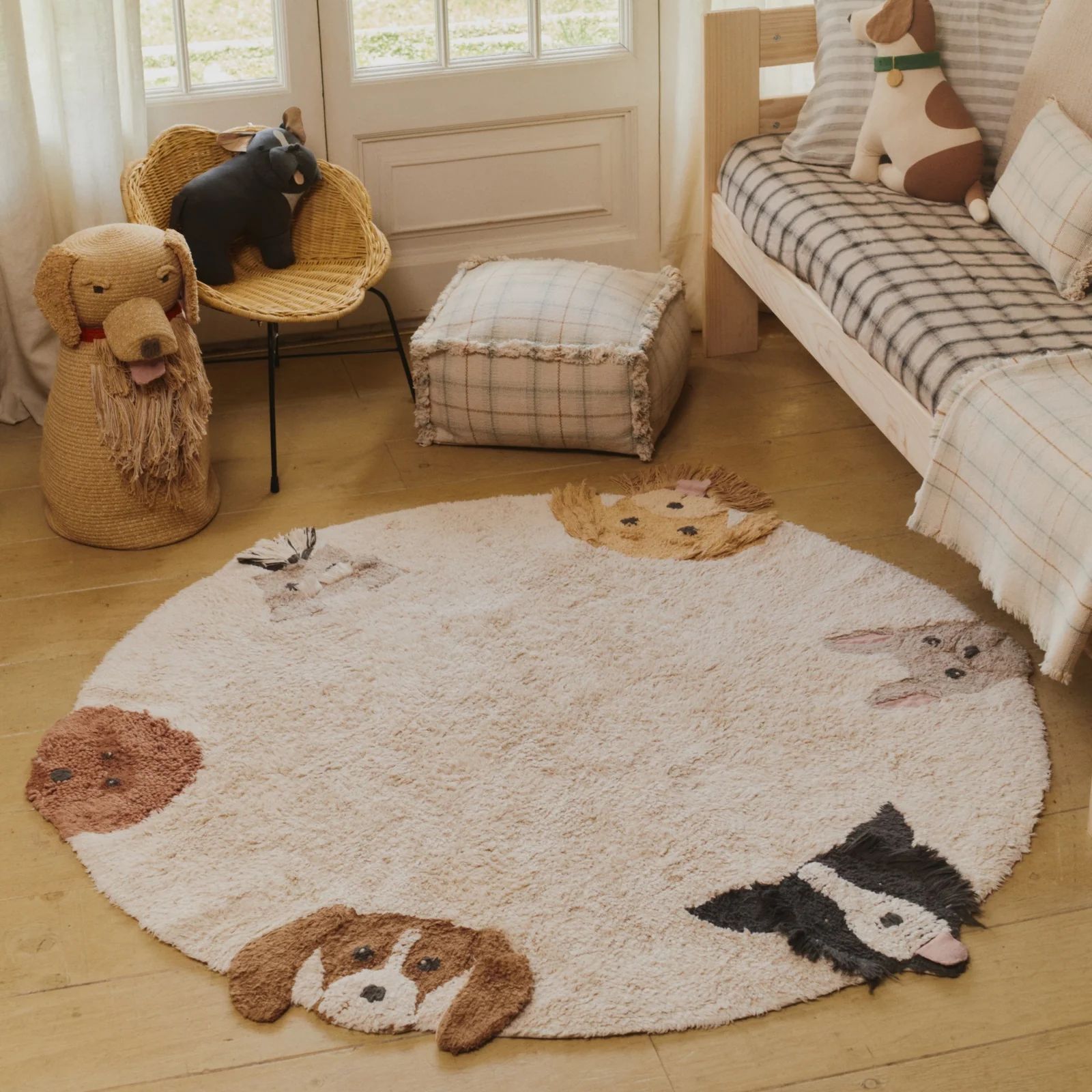 Round cream kids’ rug with playful dog faces